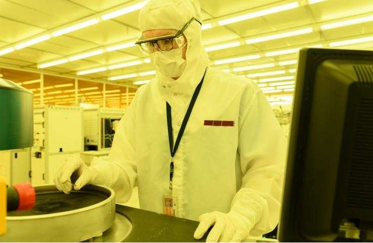 佐治亚理工学院的研究生助理Mason Chilmonczyk在反应离子蚀刻工具中的等离子体蚀刻步骤之后检查器件。这项工作正在电子和纳米技术研究所的Marcus Building洁净室进行。图片来源：乔治亚理工学院的Rob Felt